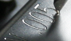 Engraved marking on a metal part.