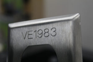Receptacle engraving with identification numbers.