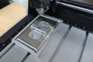 Using a custom holding fixture to hold down the receptacle plate.
